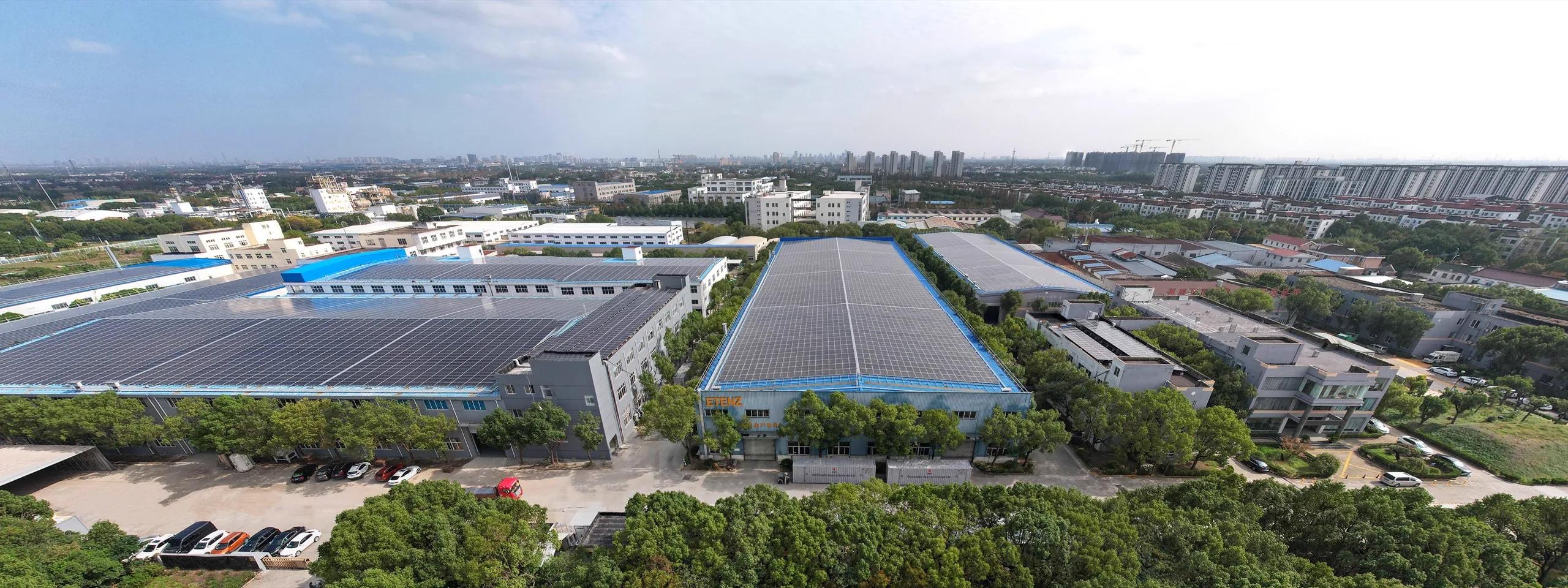 Aerial view of the ETENZ manufacturing campus with factory halls and rooftop solar panels
