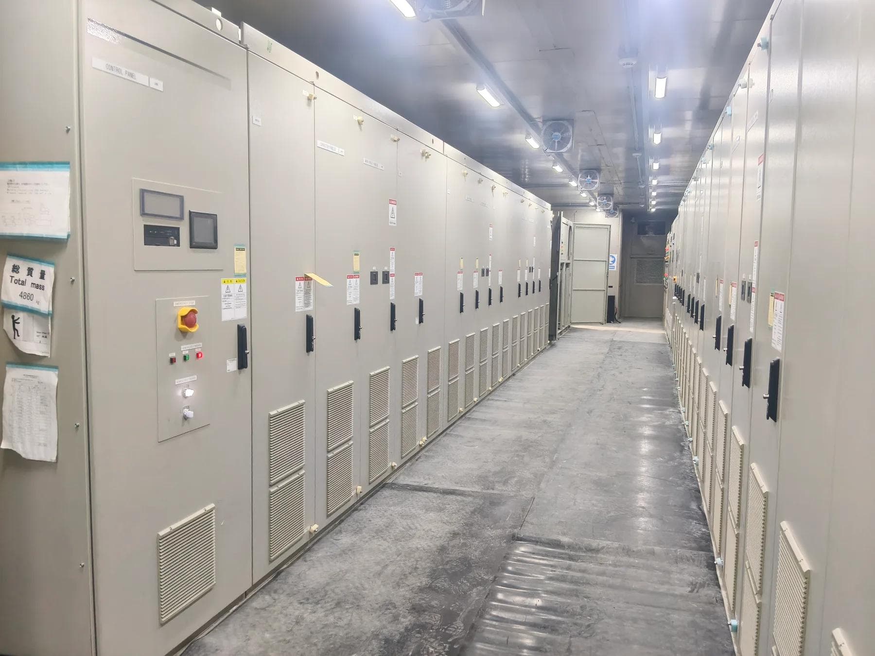 Rows of cabinets and maintenance access inside the prefabricated enclosure